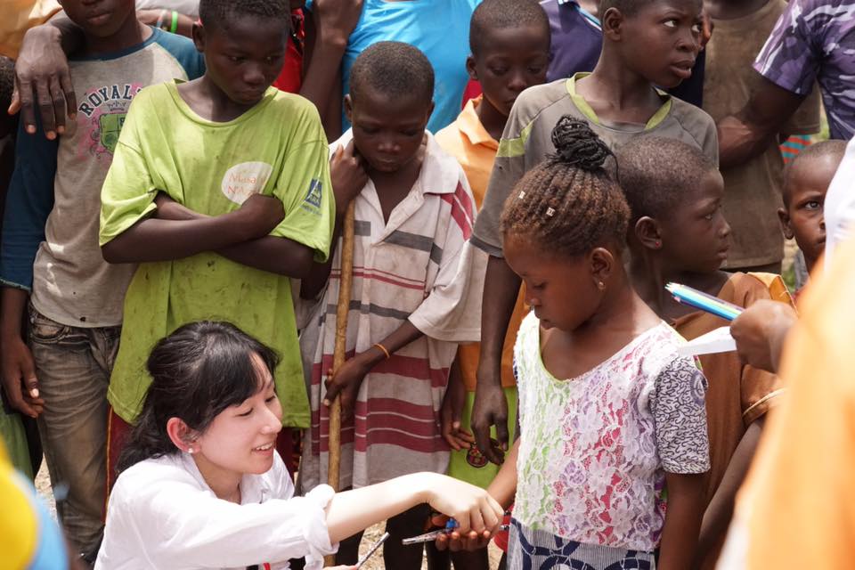 Mika Tanimoto with local children at the donated health clinic in a rural village in Ghana