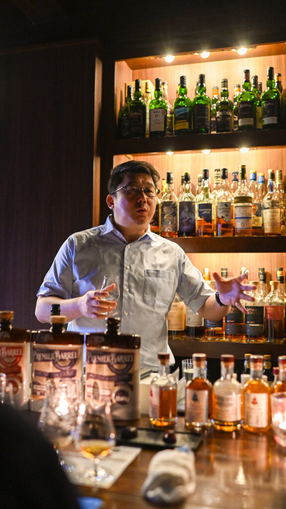 Ian Chang of Komoro Distillery pouring new-born spirit at a tasting in Hiroshima
